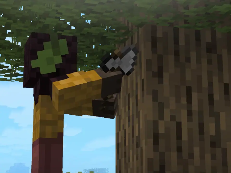 Seen from behind, a player swings an axe into the trunk of a large tree.